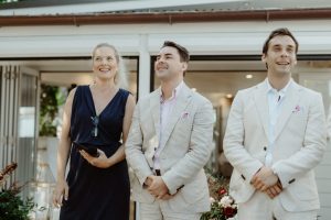 first look- Heidi Robertson, celebrant, and groom. Beach restaurant Byron Bay