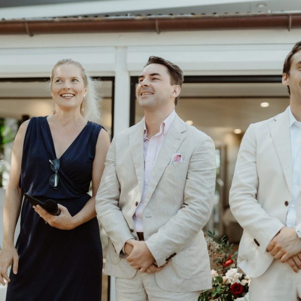 first look- Heidi Robertson, celebrant, and groom. Beach restaurant Byron Bay