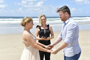 couple saying vows on the beach in Byron Bay