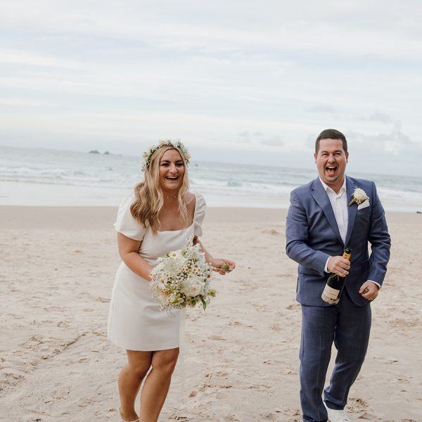 Couple popping champagne after getting married